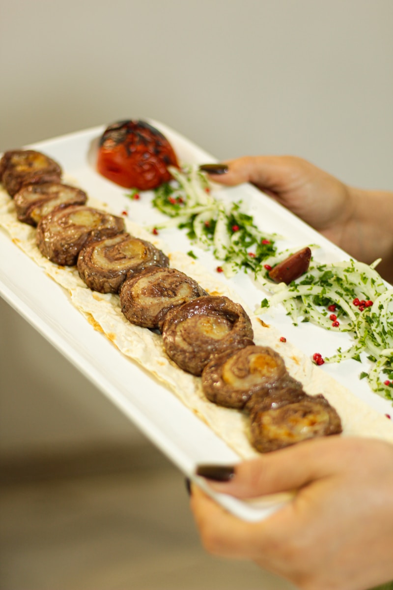 a person holding a plate with food on it