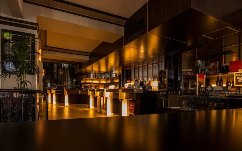 Stylish modern restaurant interior with warm lighting, elegant design, and luxurious ambiance at night.